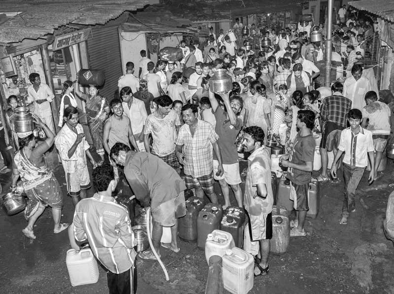 Human Right to Water in Mumbai - Rush at a group connection to collect water in the night
